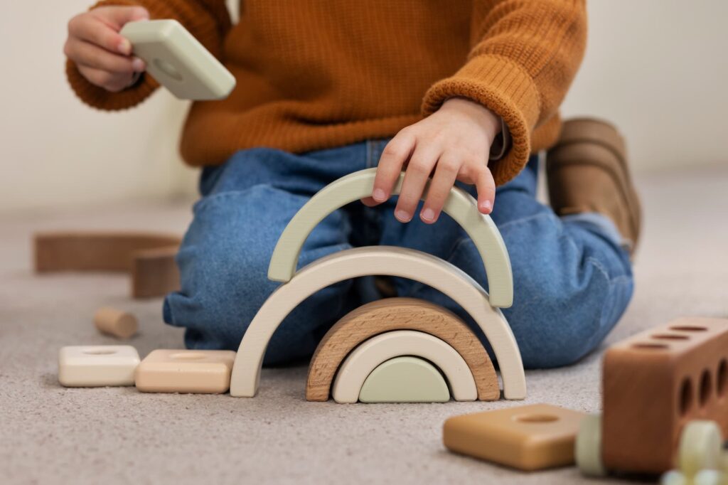front view boy playing with eco toys indoors (1)