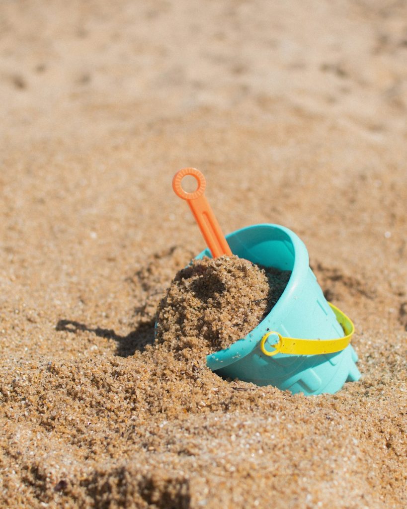Bucket with shovel in the sand