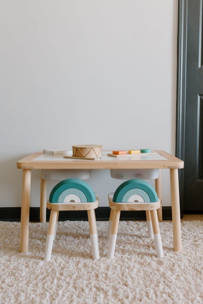 Cozy playroom setup featuring a wooden table, chairs, and toys perfect for kids.
